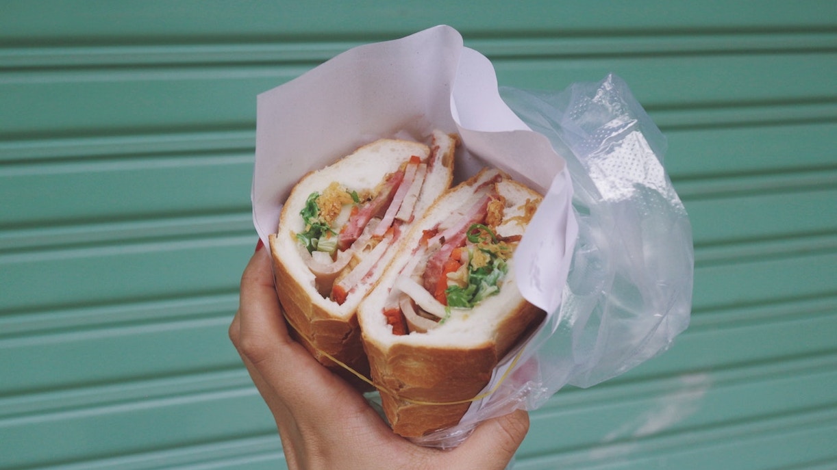 A person holding a sandwich