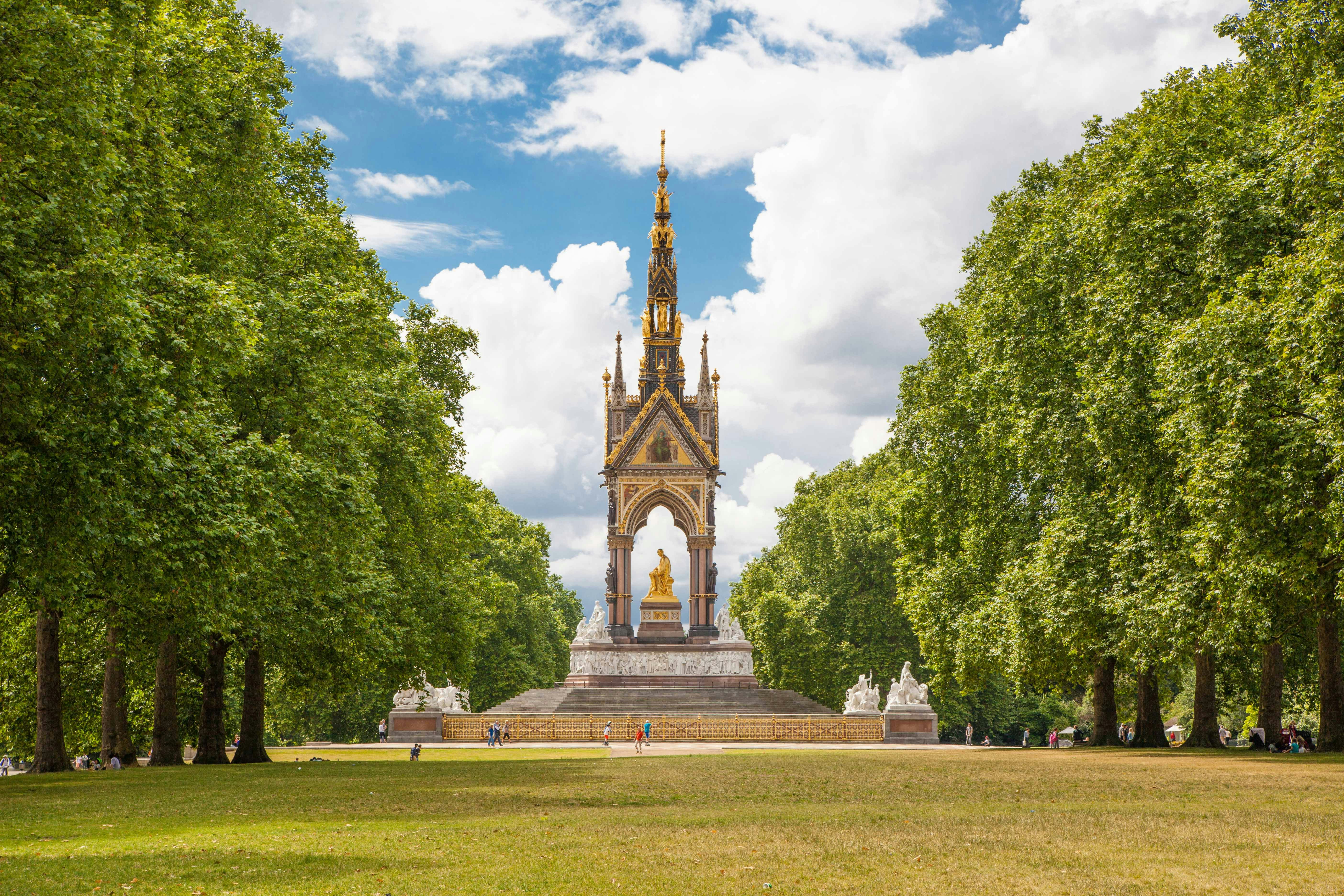 Albert Memorial in Hyde Park, London, surrounded by trees and visitors.