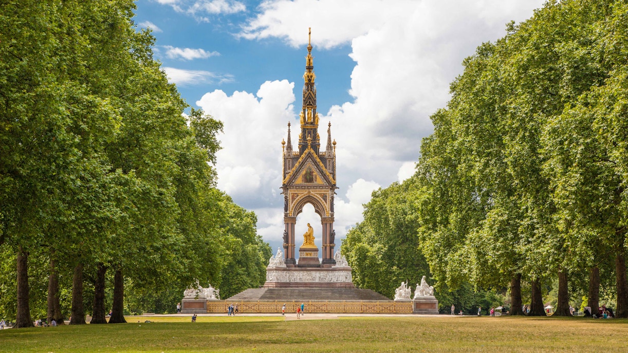 Albert Memorial in Hyde Park, London, surrounded by trees and visitors.
