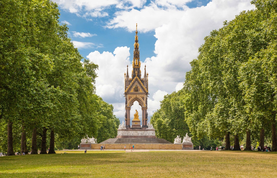 Albert Memorial in Hyde Park, London, surrounded by trees and visitors.