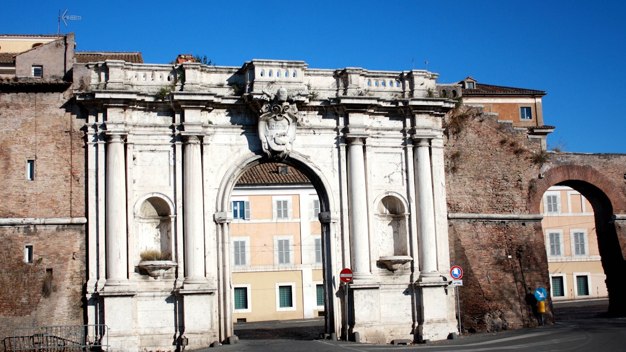 Porta Portese market stalls with shoppers browsing in Rome, Italy.