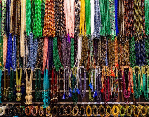 Colorful beaded necklaces displayed at Ripe Market, Dubai shopping street.
