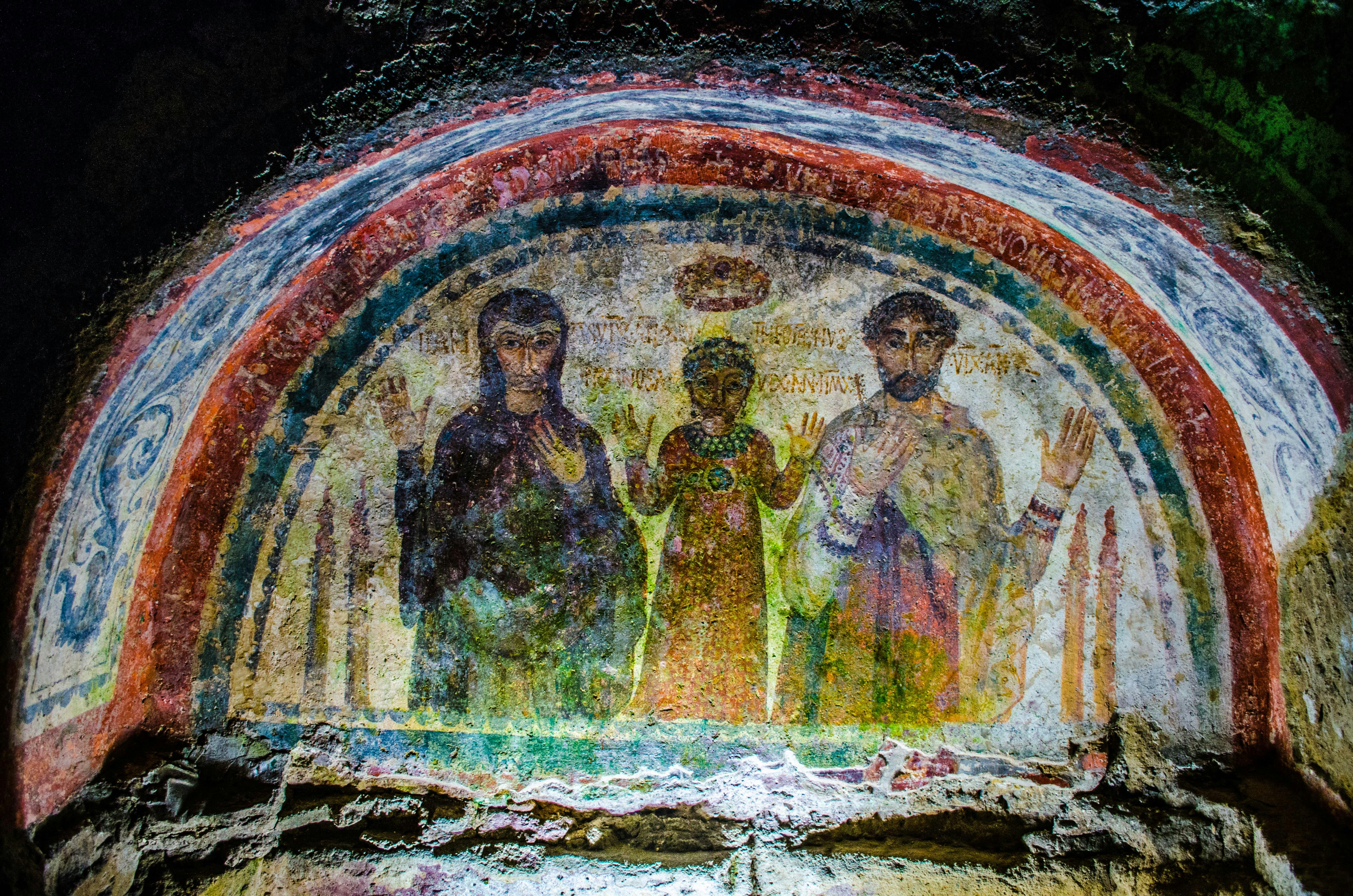 Ancient fresco in Naples Underground depicting religious figures.