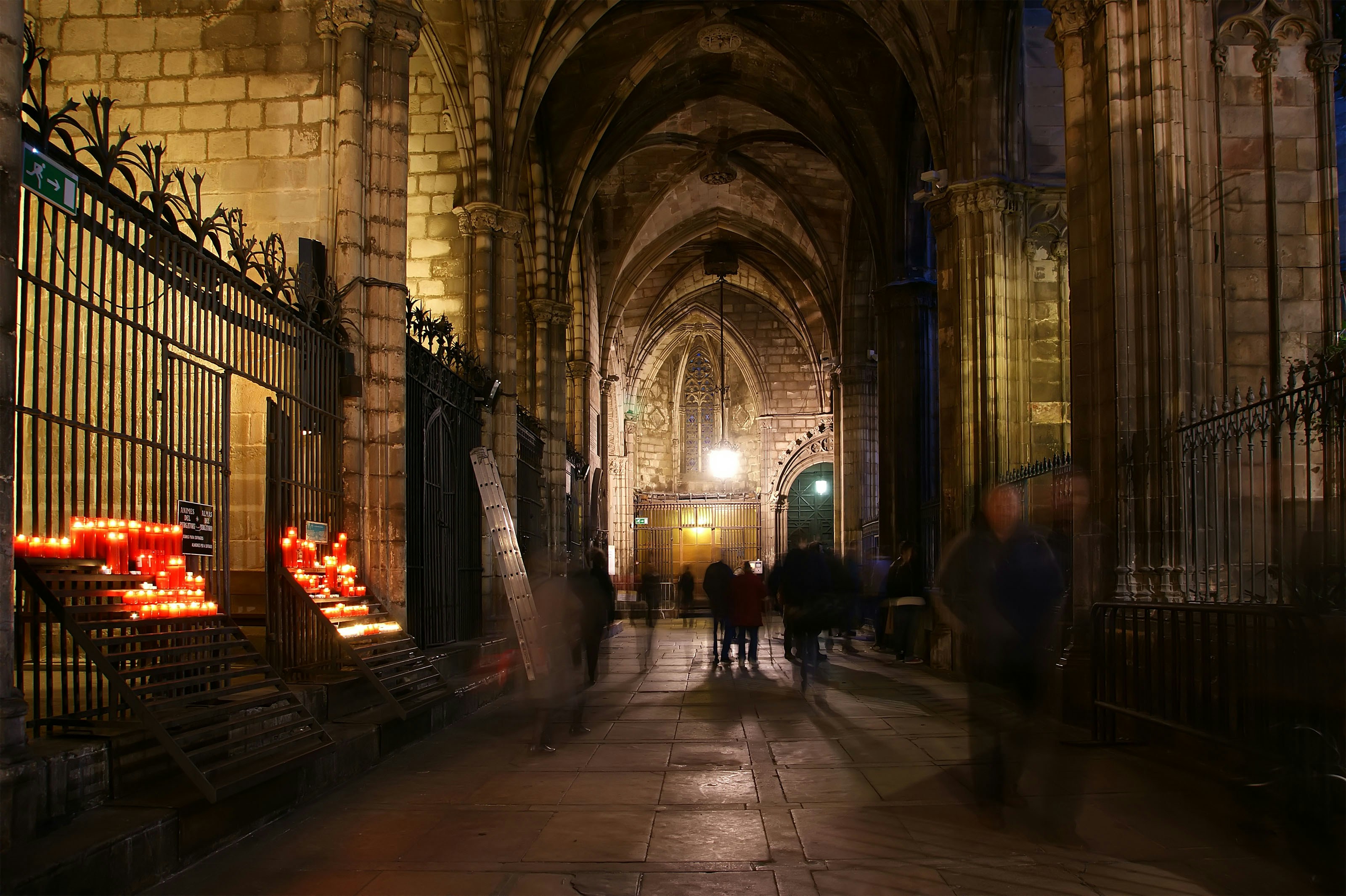 Sagrada Familia crypt interior with intricate stone arches and religious artifacts, Barcelona.