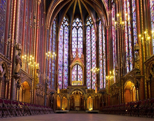 Saint Chapelle stained glass windows with natural light creating vibrant colors.