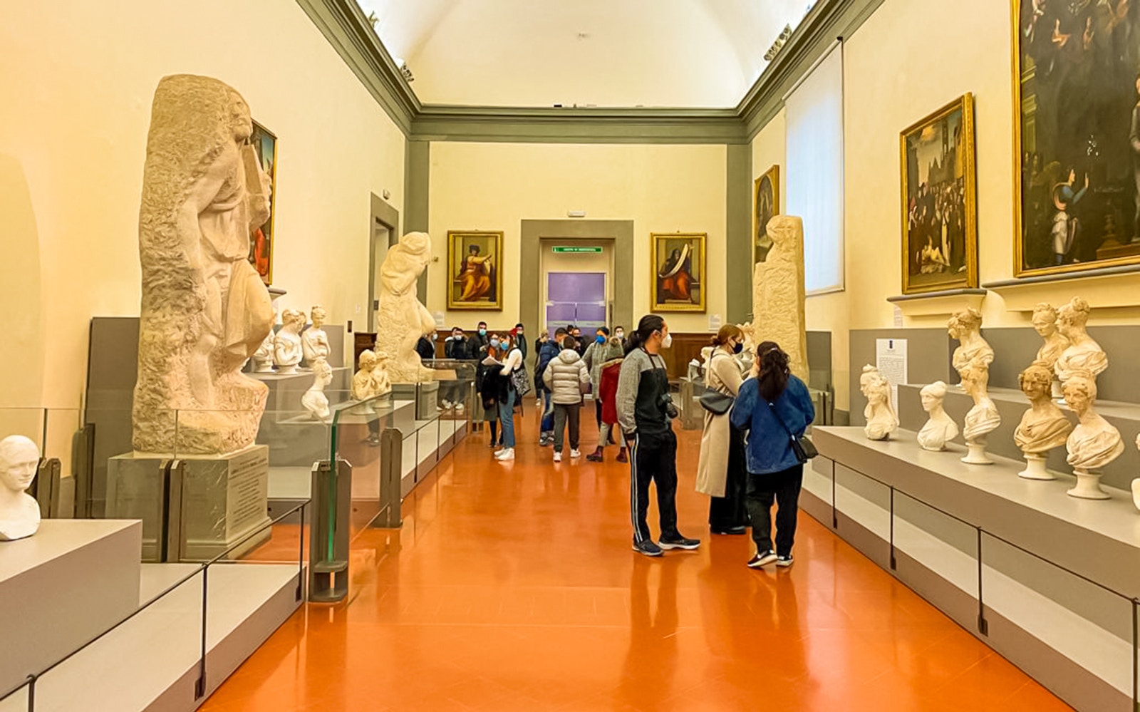 Accademia Gallery's Hall of Prisoners featuring Michelangelo's unfinished sculptures in Florence, Italy.