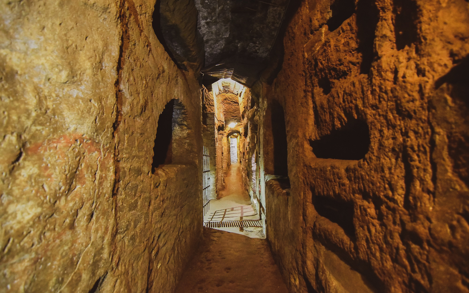 Visitors exploring ancient Roman Catacombs with guided tour insights.