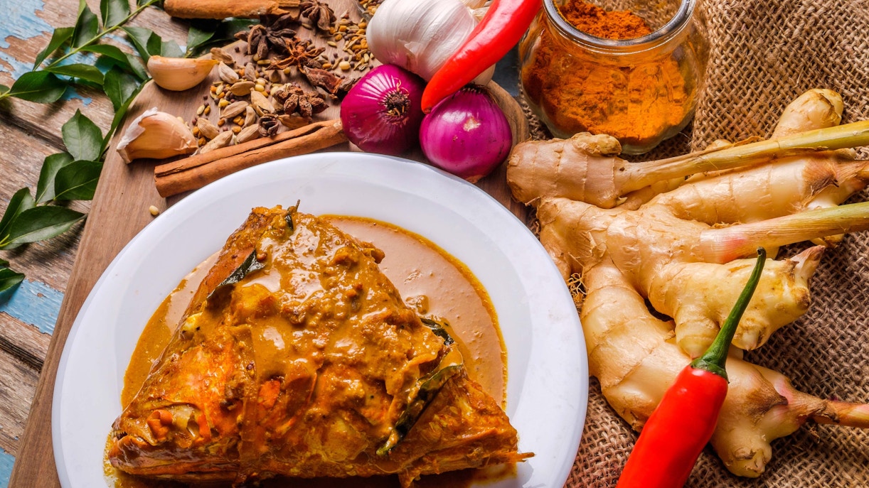 Fish Head Curry with spices and ingredients, Singapore street food.
