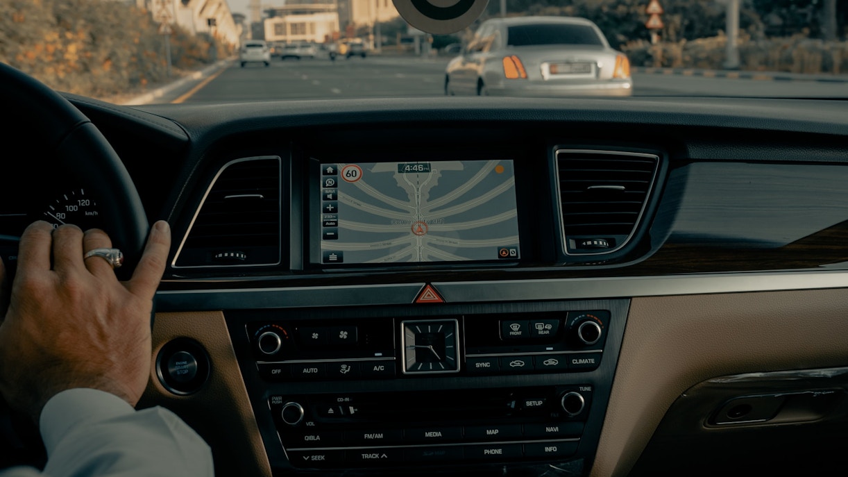 Driving through Dubai with GPS navigation in a taxi.