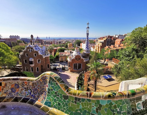 Park Guell interior view with colorful mosaic tiles and unique architectural structures in Barcelona, Spain.