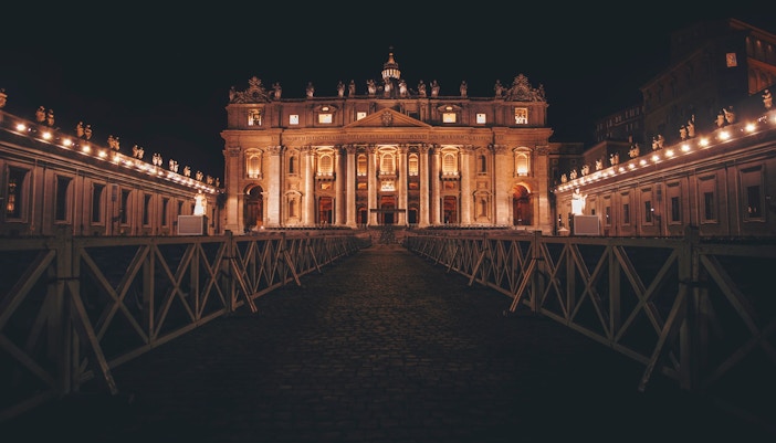 St. Peter's Basilica illuminated at night during Vatican Night Tours.