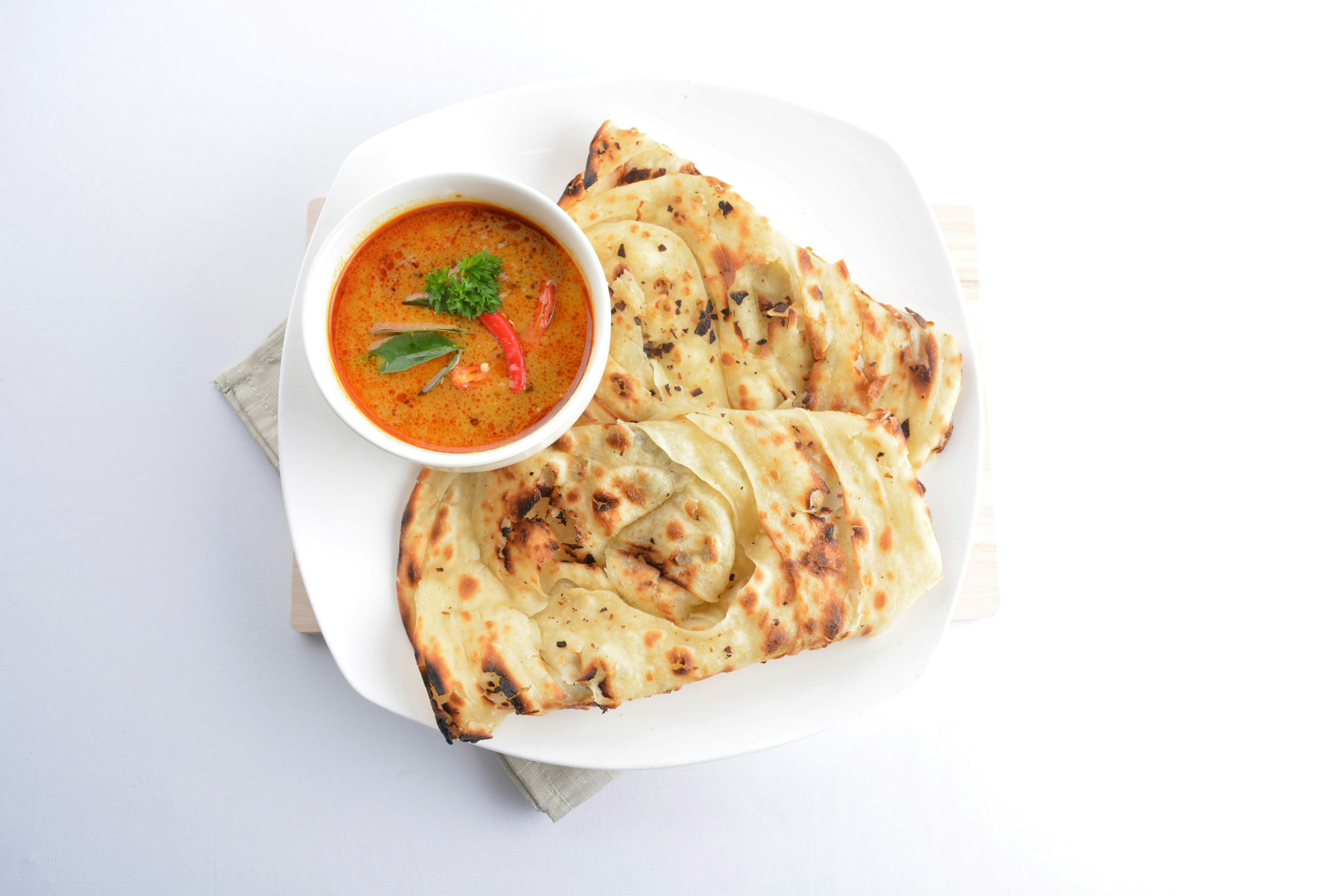 Roti Prata being prepared at a Singapore street food stall.