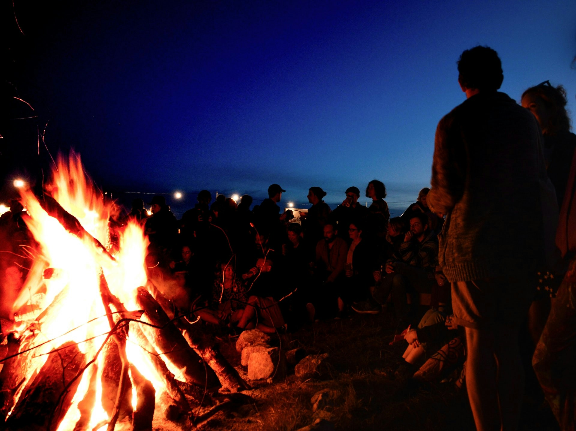 People gathered around a bonfire during a June evening in Barcelona.