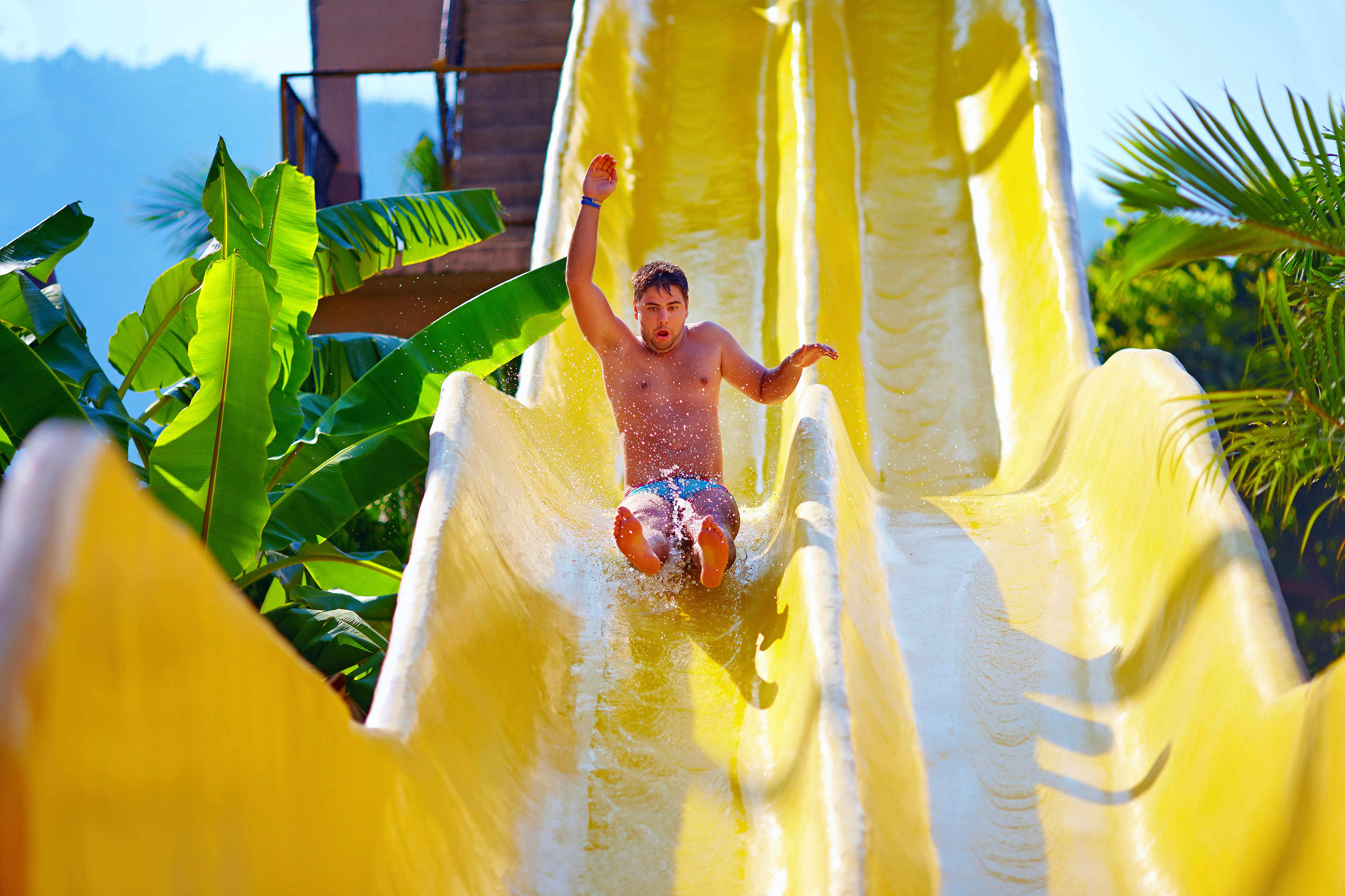 Person sliding down yellow water slide