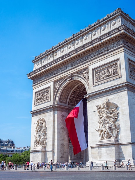 Arc de Triomphe with French flag, Paris, skip the line tickets available.