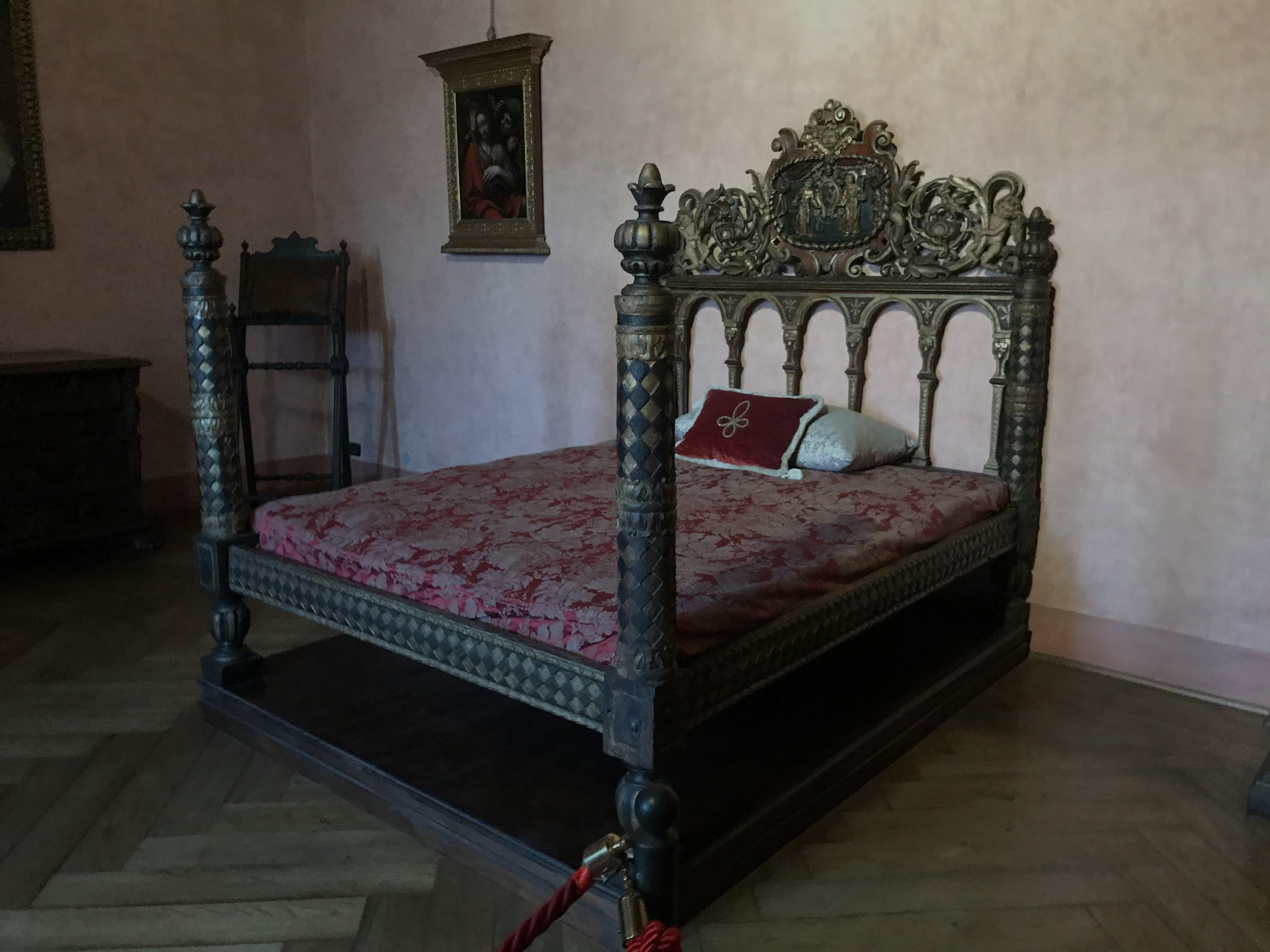 Castel Sant'Angelo Papal Apartments ornate bed with carved headboard.