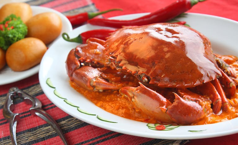 Chili crab dish served at a restaurant in Singapore, featured in the Singapore Travel Guide.