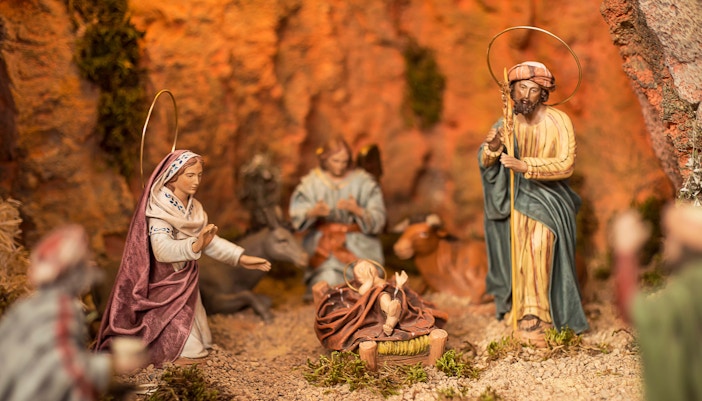 Sagrada Familia crypt mass with attendees seated in Barcelona, Spain.