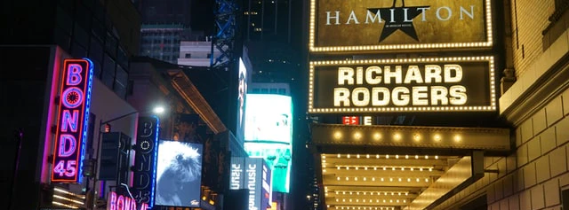 Broadway theaters at night with Hamilton sign at Richard Rodgers Theatre, New York City.