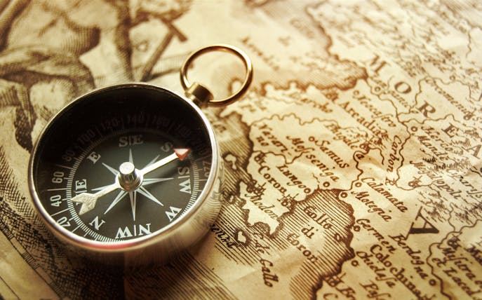 Compass on vintage map highlighting "The Longest Con" tour theme.