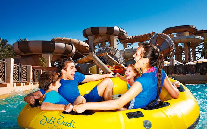Family enjoying a water ride at Wild Wadi Waterpark, Dubai.