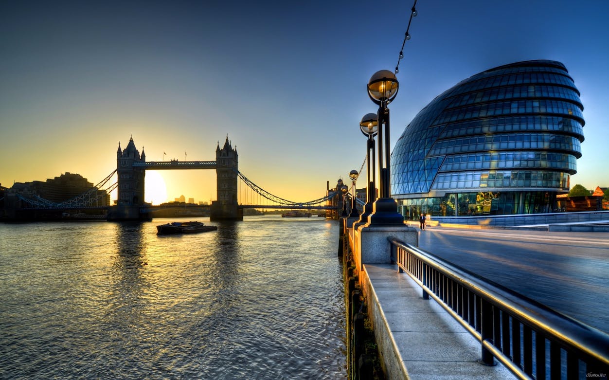 Tower Bridge and City Hall at sunrise, London, view from the Thames River.