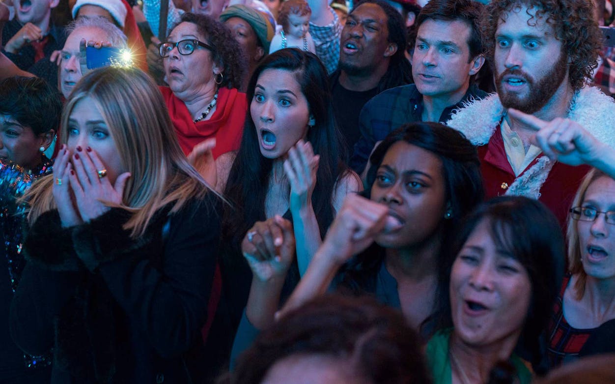 Crowd reacting with surprise and excitement at an office Christmas party event.
