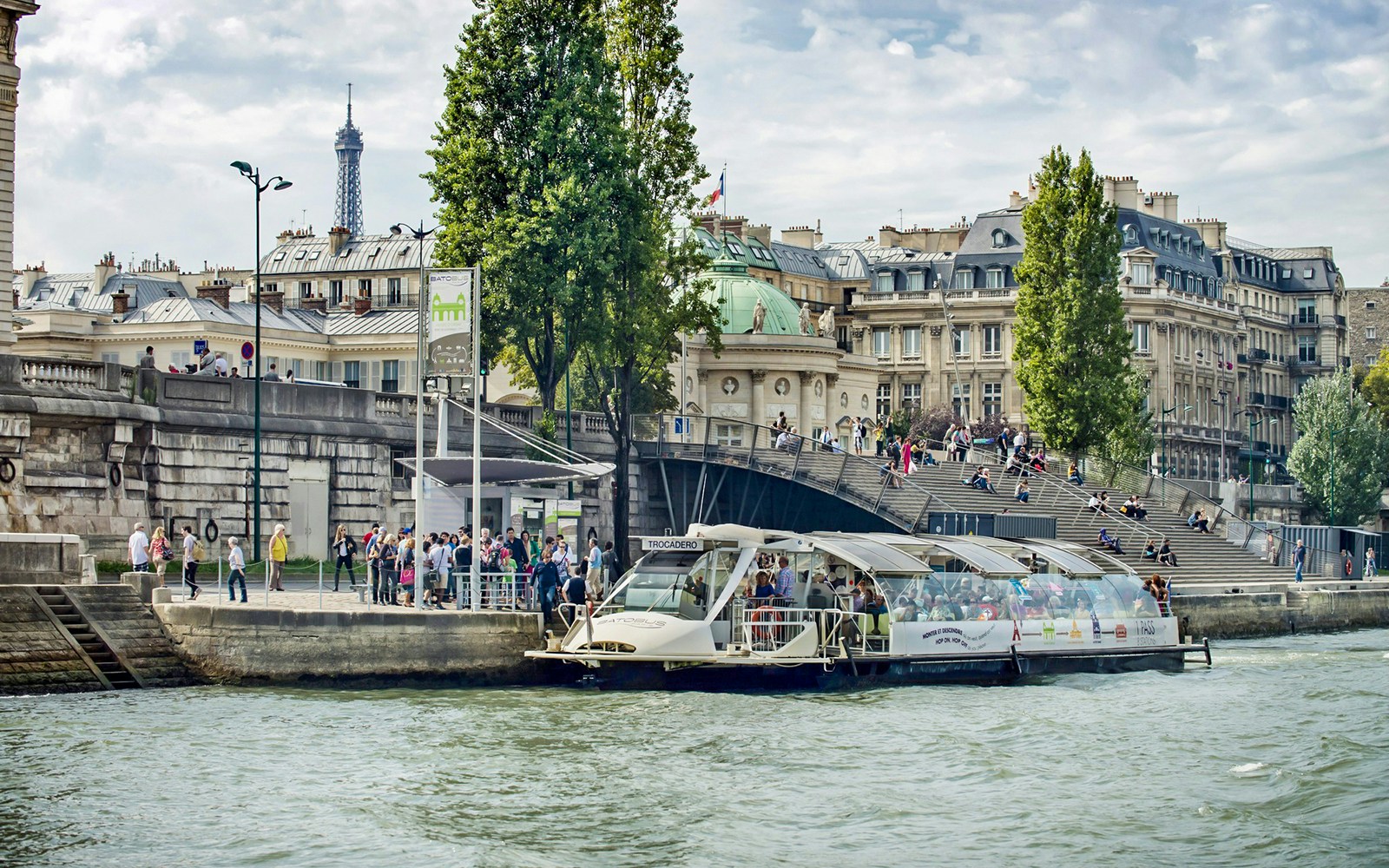 Seine River with Batobus hop-on-hop-off cruise boat near Eiffel Tower, Paris.