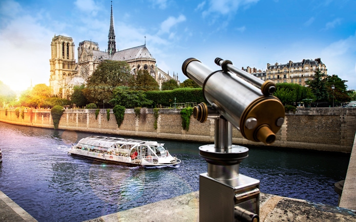 Batobus cruising on the Seine River near Notre-Dame Cathedral in Paris.