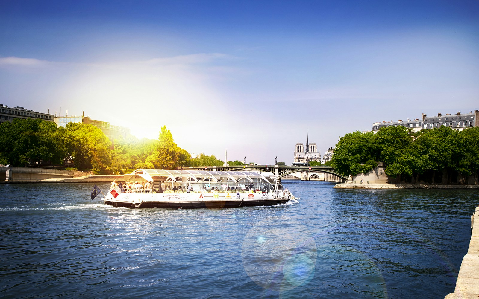 Seine River with Batobus hop-on-hop-off cruise boat near Eiffel Tower, Paris.