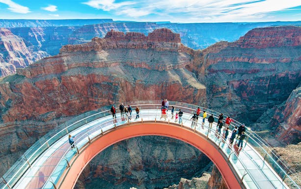 Visitors on the Skywalk at Grand Canyon West Rim, overlooking the canyon.