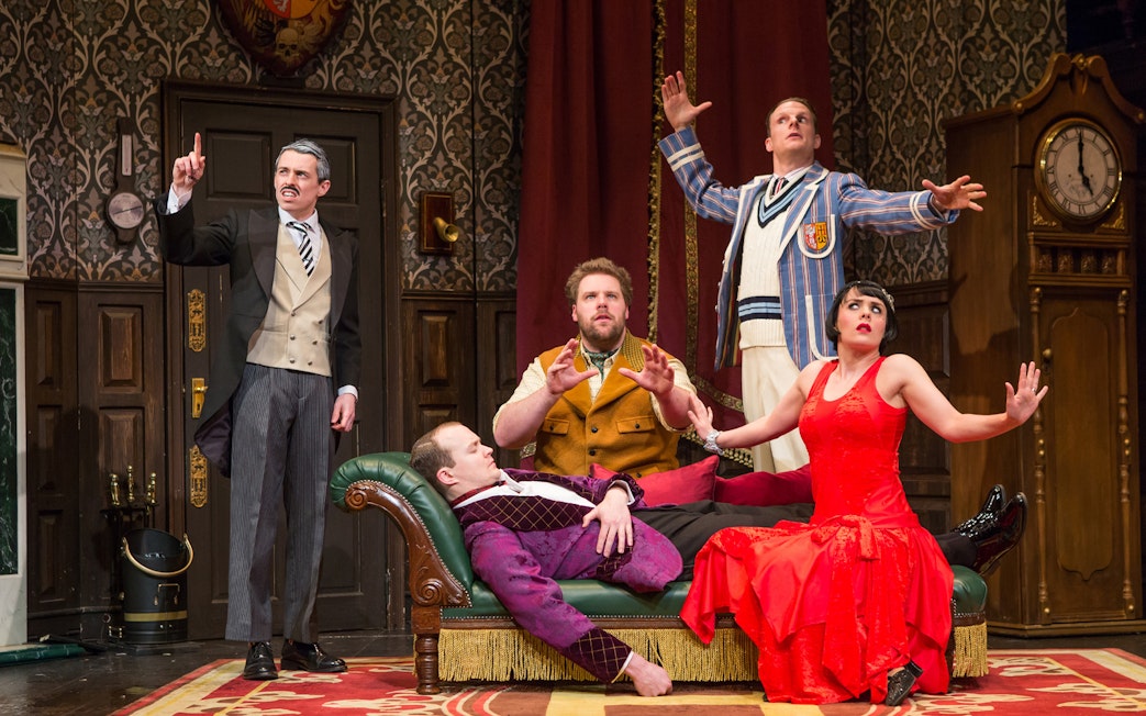 Actors performing a scene from "The Play That Goes Wrong" on stage.