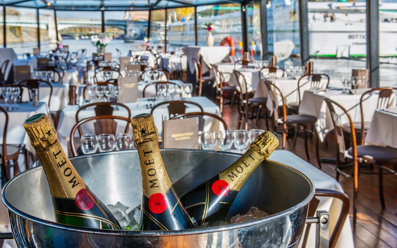 Seine River dinner cruise with wine, view of Paris landmarks from La Marina boat.