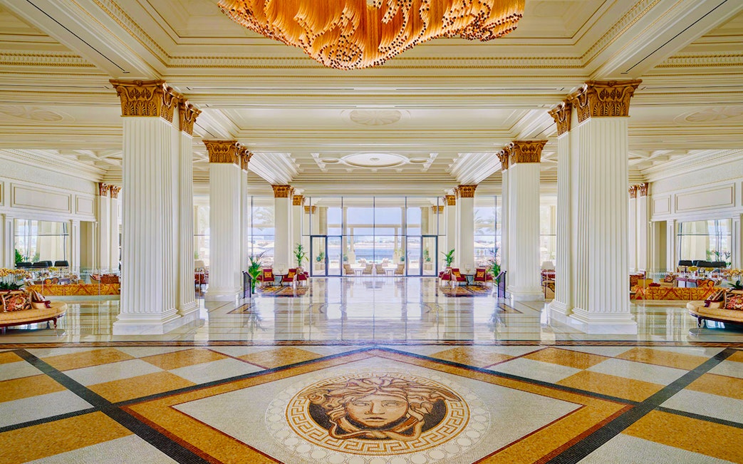 Palazzo Versace's Mosaico Lobby Lounge with elegant columns and intricate floor mosaic.