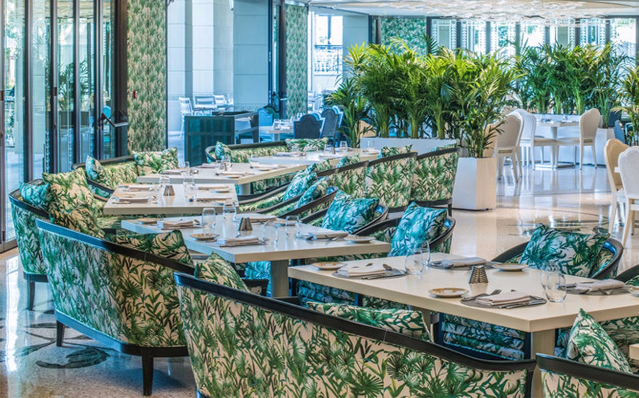 Giardino Restaurant dining area with tropical decor at Palazzo Versace.