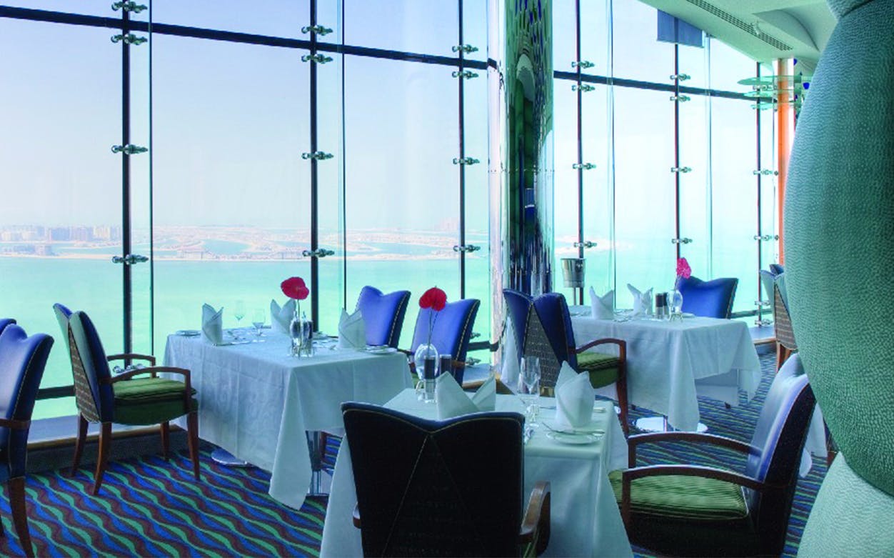 Dining experience at Al Muntaha restaurant in Burj Al Arab, Dubai, with panoramic city views.