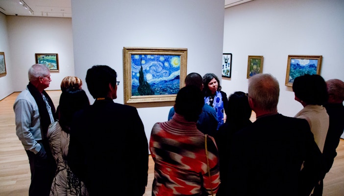 Group viewing "The Starry Night" at MoMA during a quiet morning tour.