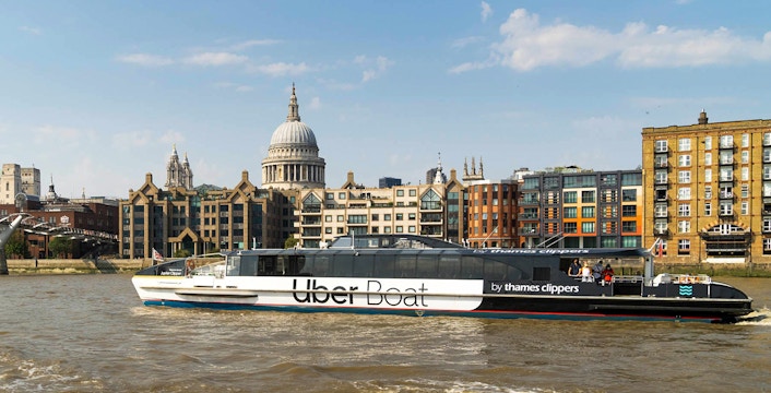 Uber Boat on the Thames with St. Paul's Cathedral in the background, London.
