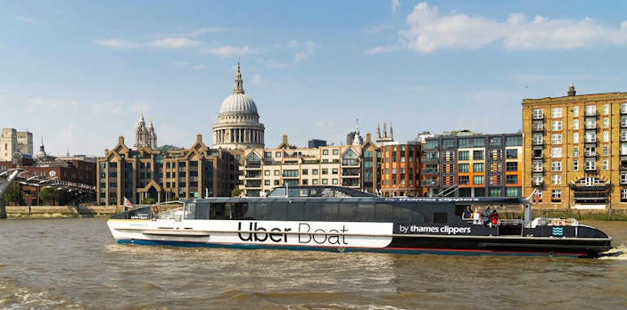 Uber Boat on the Thames with St. Paul's Cathedral in the background, London.
