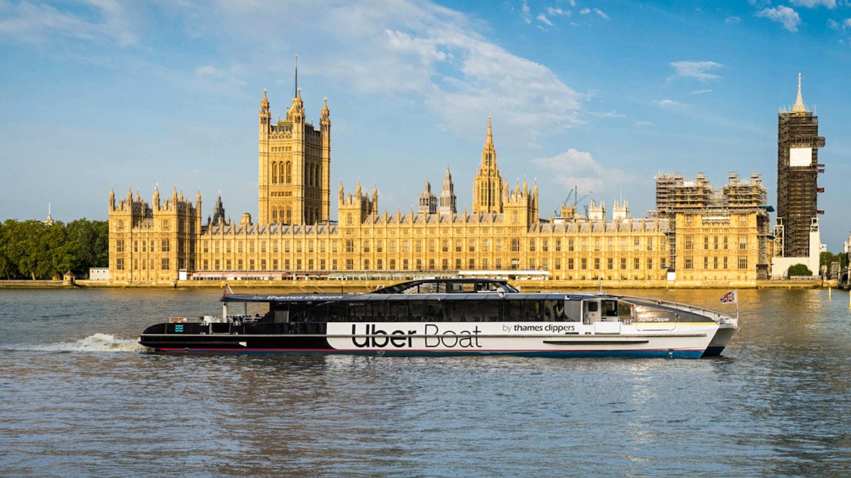 Uber Boat on the River Thames with the Houses of Parliament in London.