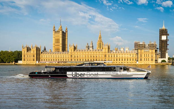 Uber Boat on the River Thames with the Houses of Parliament in London.