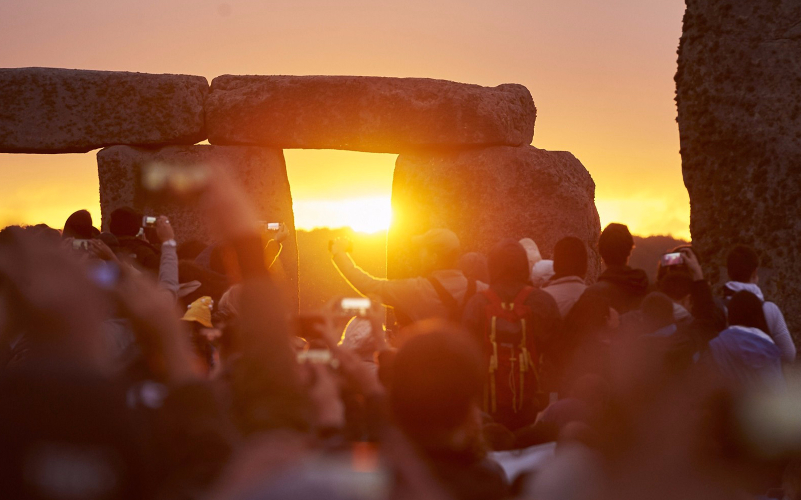 Stonehenge stone circle with tourists during private viewing, Roman Baths tour, London.