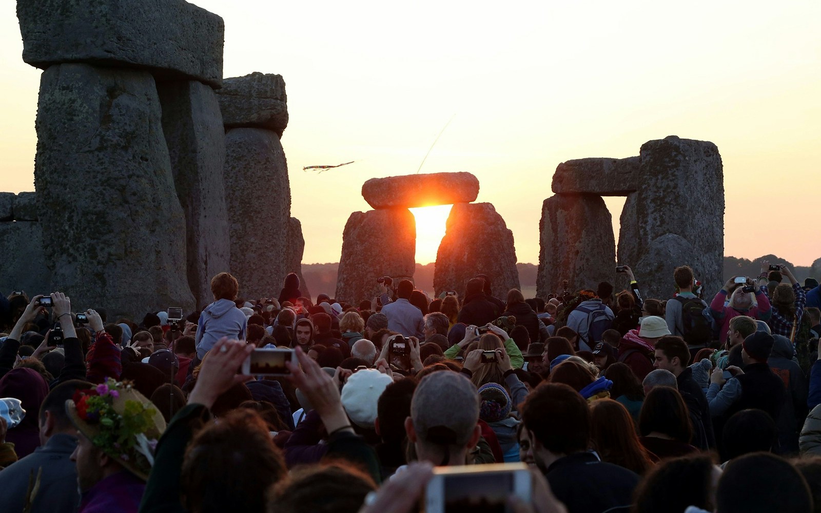 Crowd watching sunrise at Stonehenge during a private tour.