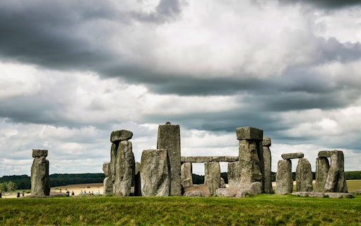 Stonehenge under cloudy skies in Wiltshire, England.
