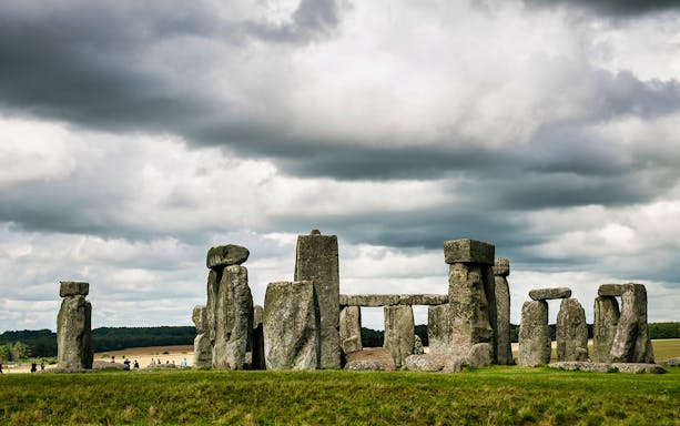 Stonehenge under cloudy skies in Wiltshire, England.