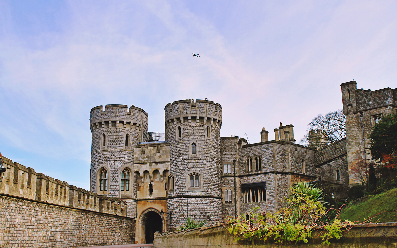 Windsor Castle stone towers and walls under a blue sky.
