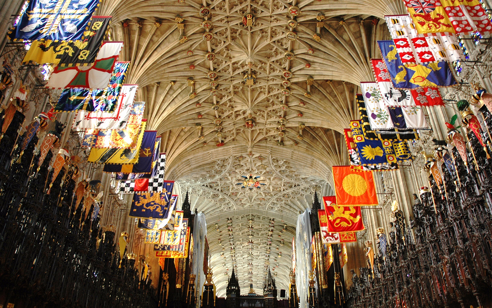 Intricate ceiling and colorful banners inside St George's Chapel, Windsor Castle.