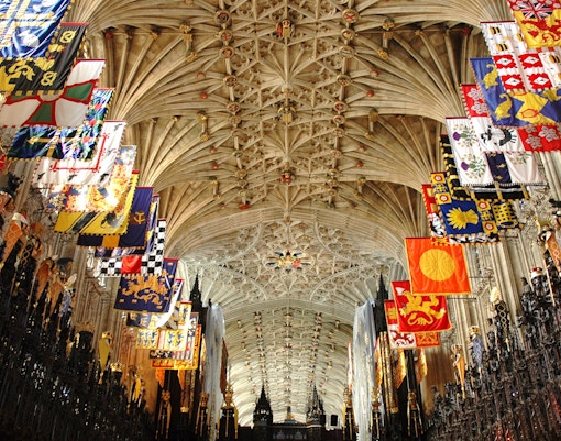 Intricate ceiling and colorful banners inside St George's Chapel, Windsor Castle.