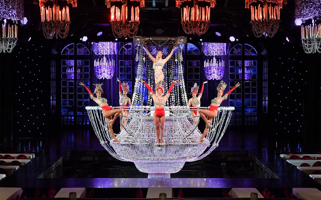 Performers on a chandelier stage at The Lido Show, Paris.