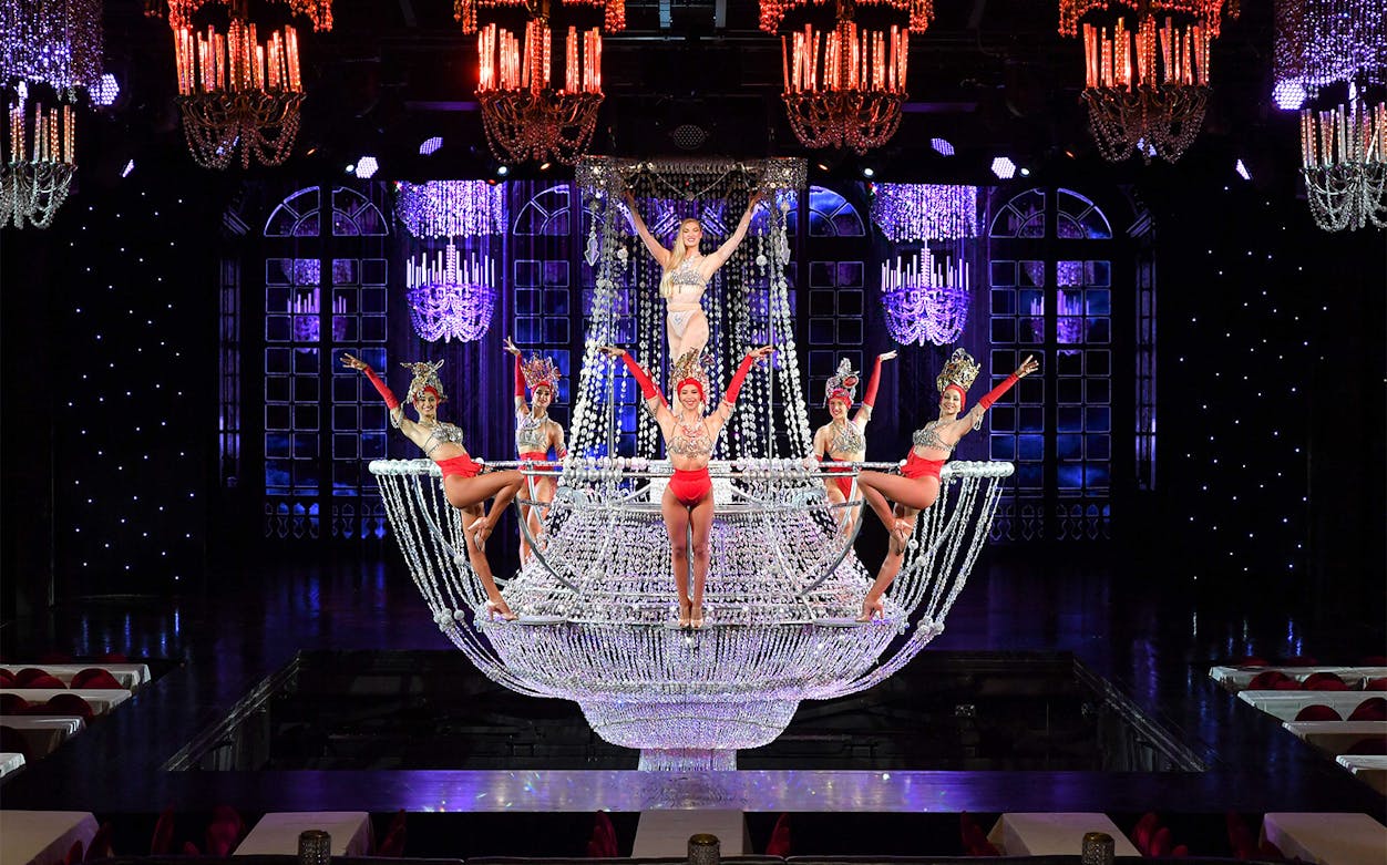 Performers on a chandelier stage at The Lido Show, Paris.